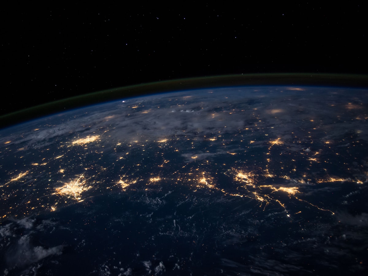 Earth at night from space with city lights glowing